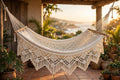 Nicaraguan woven double hammock, handmade with fringe, hanging between cedar trees