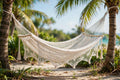 Yucatán double hammock in natural undyed cotton hanging between cedar trees