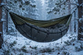 Winter insulated underquilt in charcoal fitted beneath a camping hammock in snow